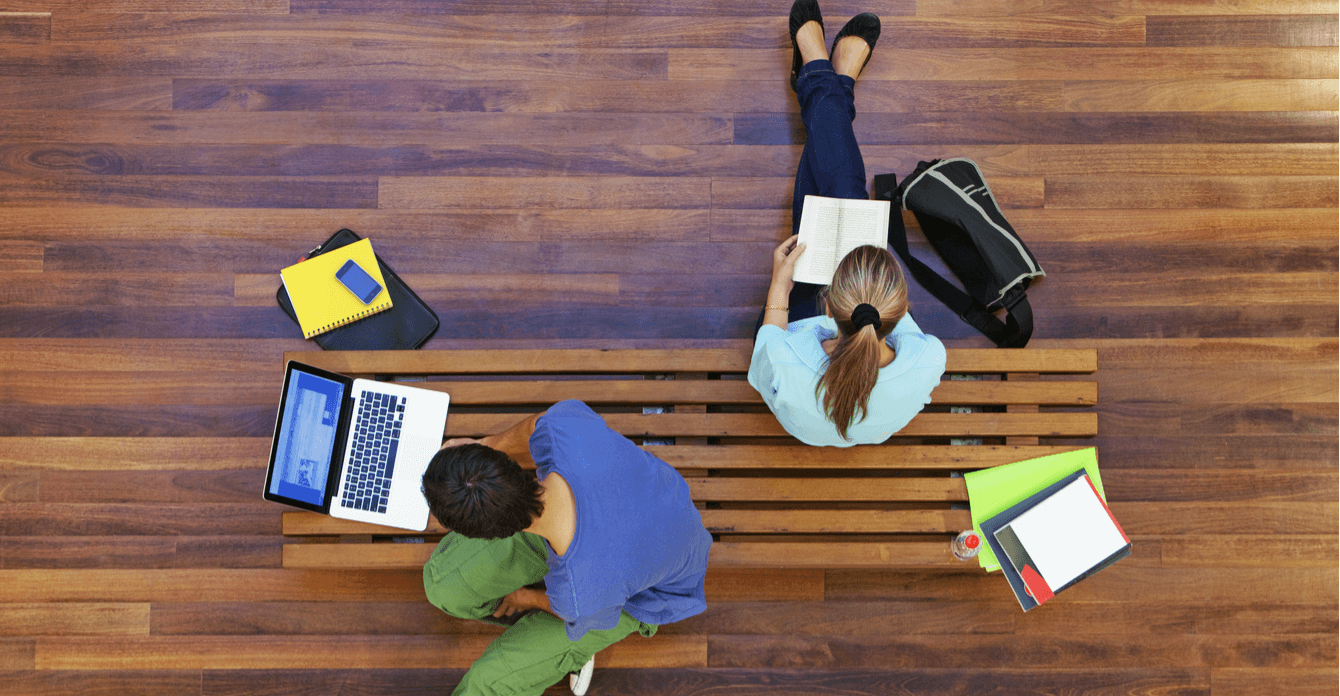 students on laptop and reading book studying