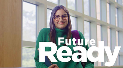 Austin Williams, a person with glasses and long hair wearing a green sweater, stands in front of large windows, holding a book and a backpack. The text 