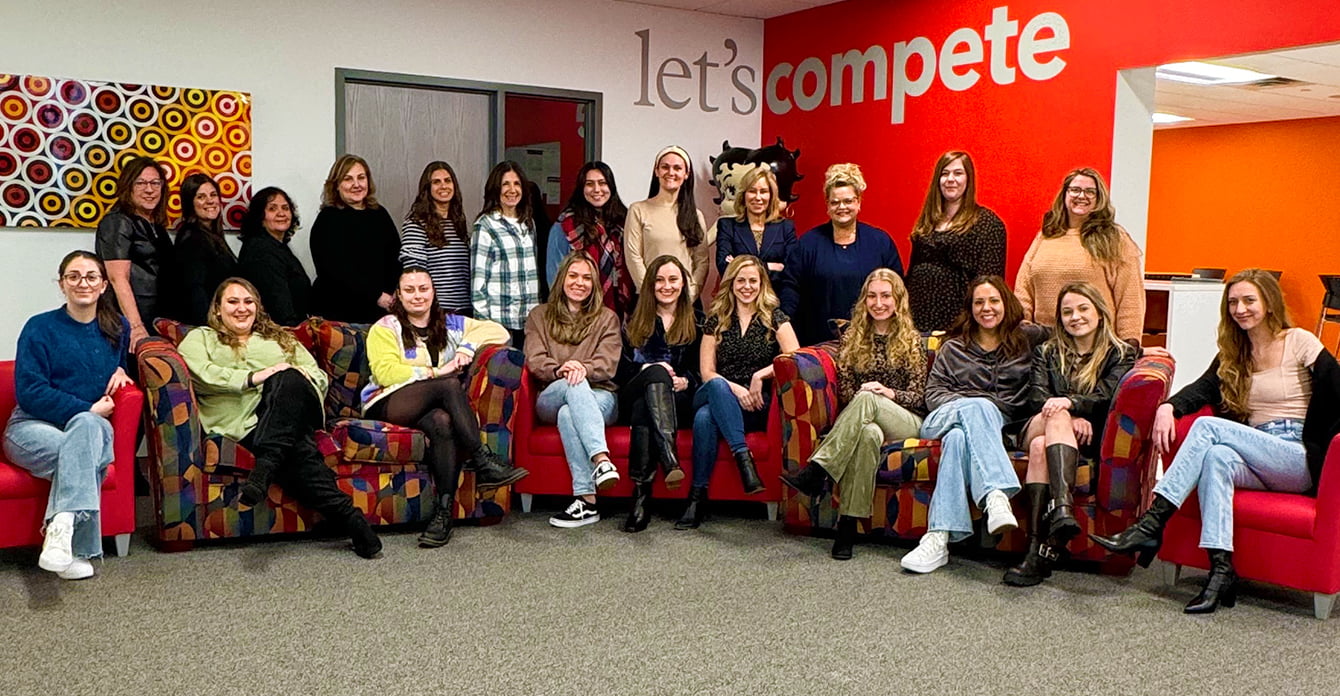 Women of AW posing for a picture in the office